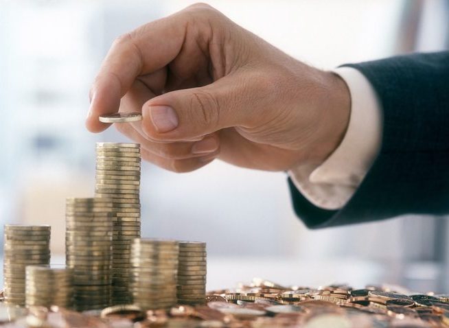 Businessman is stacking coins